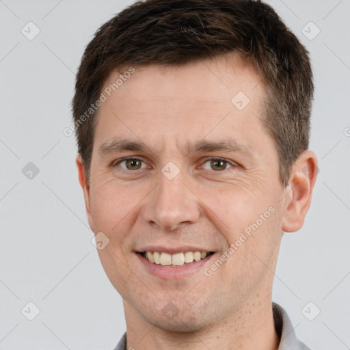 Joyful white adult male with short  brown hair and brown eyes