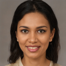 Joyful black young-adult female with medium  brown hair and brown eyes