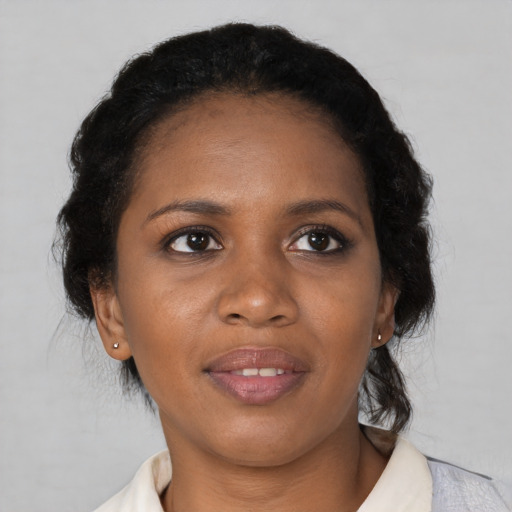 Joyful black young-adult female with short  brown hair and brown eyes
