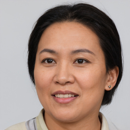 Joyful white adult female with medium  brown hair and brown eyes