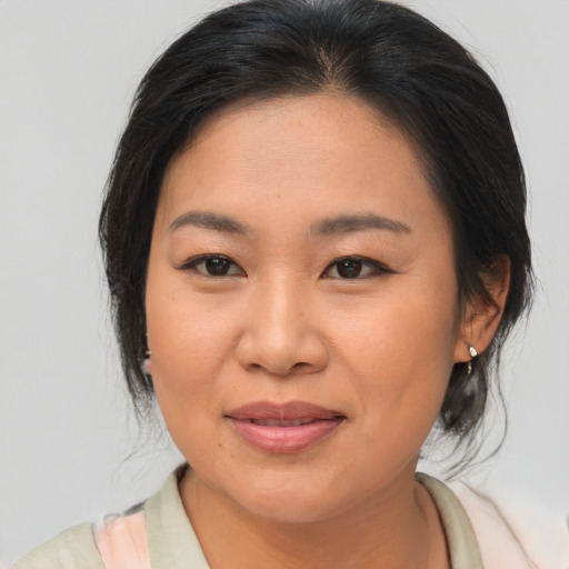 Joyful asian young-adult female with medium  brown hair and brown eyes