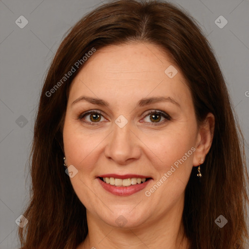 Joyful white adult female with long  brown hair and brown eyes