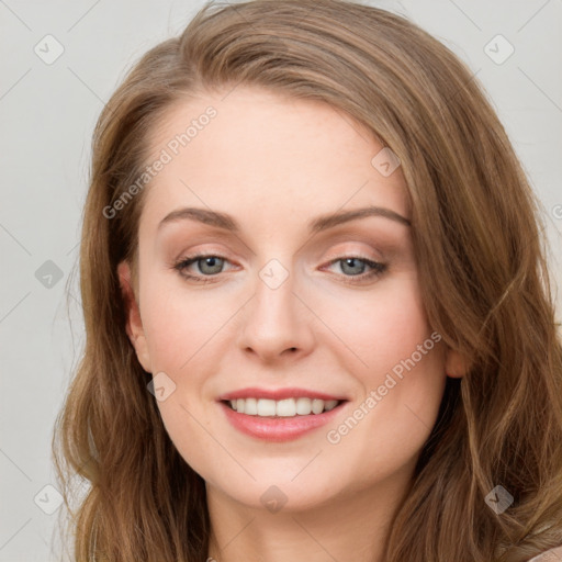 Joyful white young-adult female with long  brown hair and blue eyes