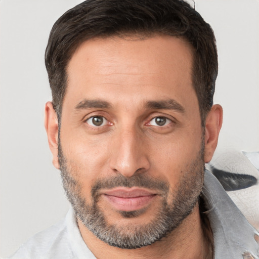 Joyful white adult male with short  brown hair and brown eyes