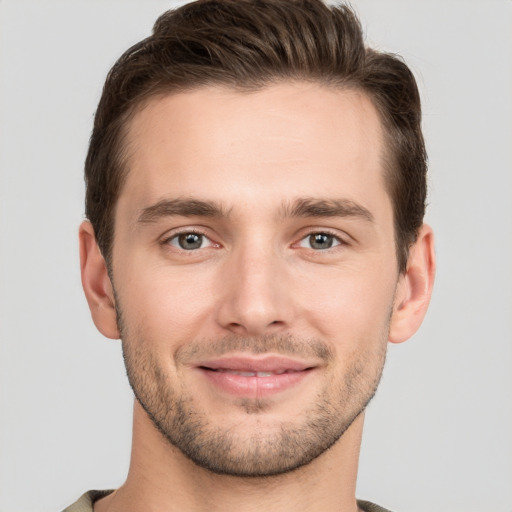 Joyful white young-adult male with short  brown hair and grey eyes