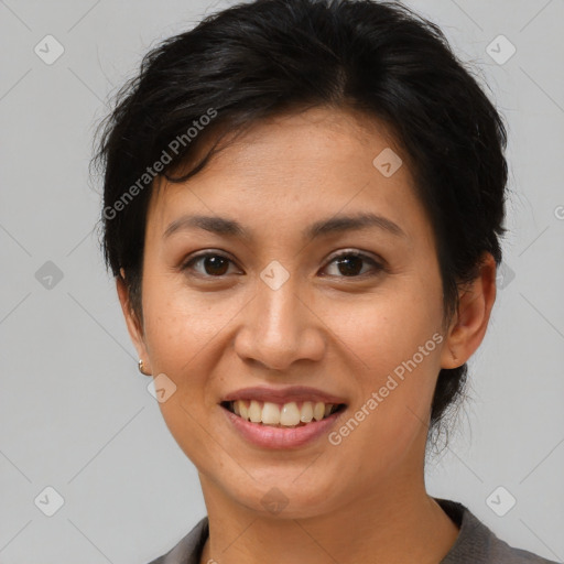 Joyful asian young-adult female with short  brown hair and brown eyes