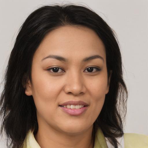 Joyful latino young-adult female with medium  brown hair and brown eyes