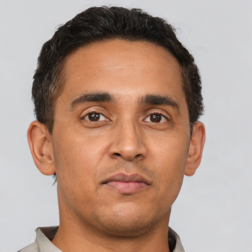 Neutral latino young-adult male with short  black hair and brown eyes