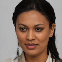 Joyful latino young-adult female with medium  black hair and brown eyes