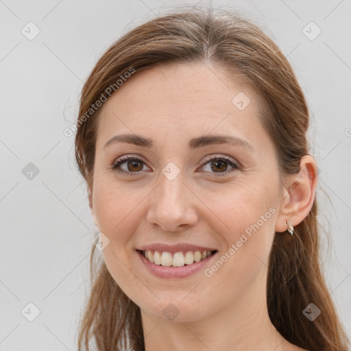 Joyful white young-adult female with long  brown hair and grey eyes