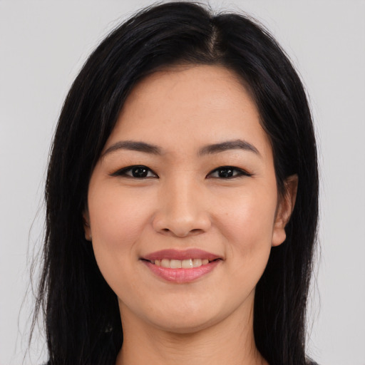 Joyful asian young-adult female with long  black hair and brown eyes