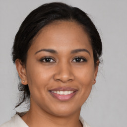 Joyful latino young-adult female with medium  brown hair and brown eyes