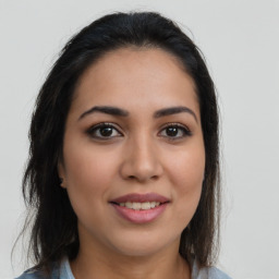 Joyful latino young-adult female with long  brown hair and brown eyes