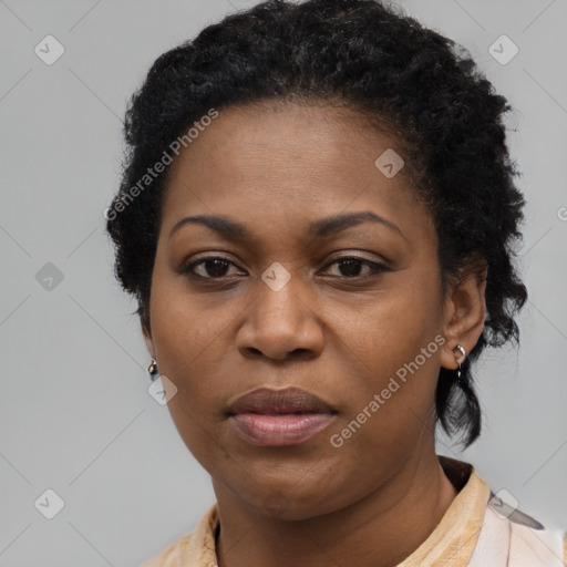 Joyful black adult female with short  black hair and brown eyes