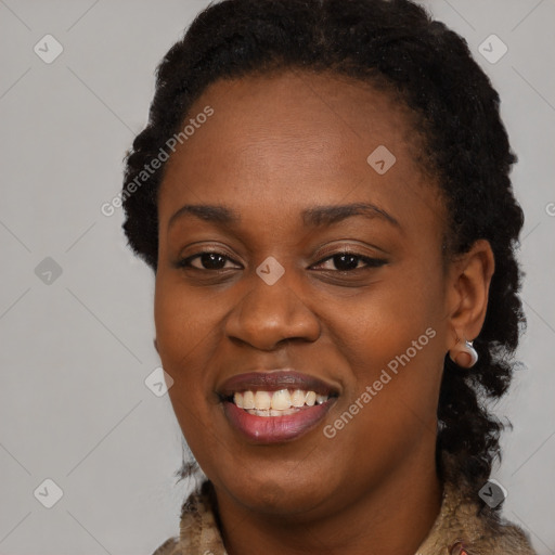 Joyful black young-adult female with long  brown hair and brown eyes