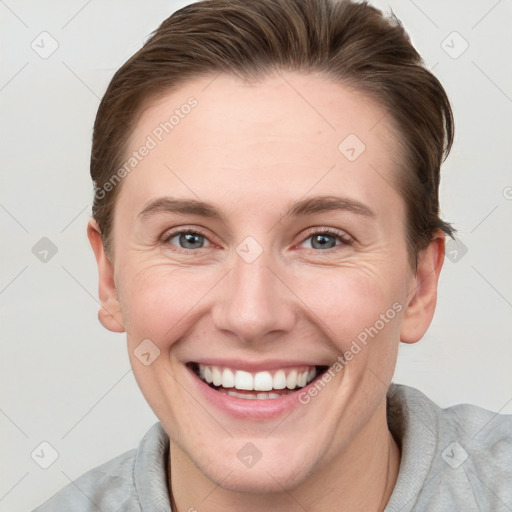 Joyful white young-adult female with short  brown hair and grey eyes