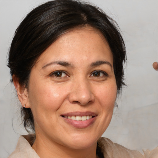 Joyful white adult female with medium  brown hair and brown eyes