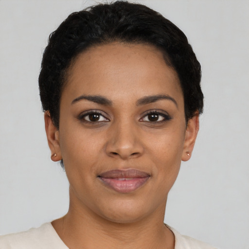 Joyful latino young-adult female with short  black hair and brown eyes