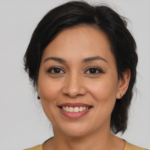 Joyful white adult female with medium  brown hair and brown eyes