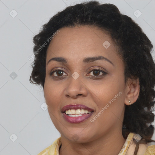 Joyful black young-adult female with long  brown hair and brown eyes