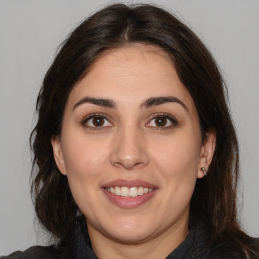 Joyful white young-adult female with medium  brown hair and brown eyes