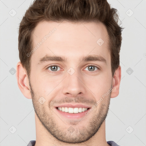 Joyful white young-adult male with short  brown hair and grey eyes