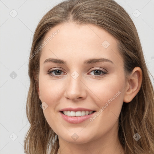 Joyful white young-adult female with long  brown hair and grey eyes