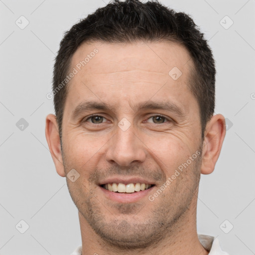 Joyful white adult male with short  brown hair and brown eyes