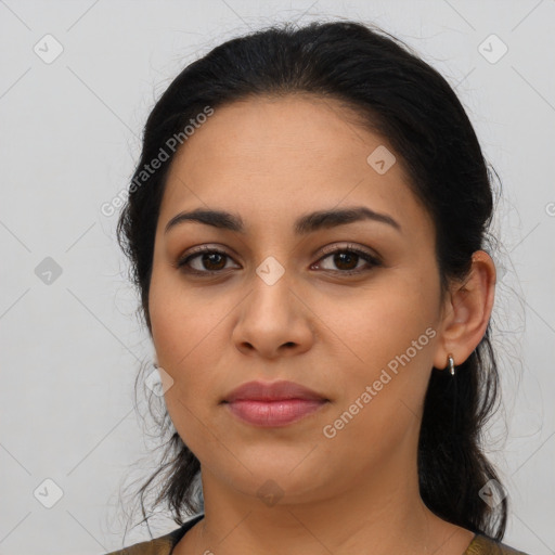 Joyful latino young-adult female with long  black hair and brown eyes