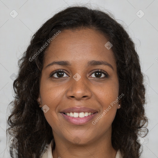 Joyful black young-adult female with long  brown hair and brown eyes