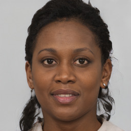 Joyful black young-adult female with short  brown hair and brown eyes