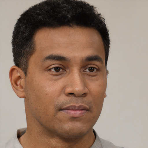 Neutral latino young-adult male with short  brown hair and brown eyes
