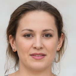 Joyful white young-adult female with medium  brown hair and brown eyes