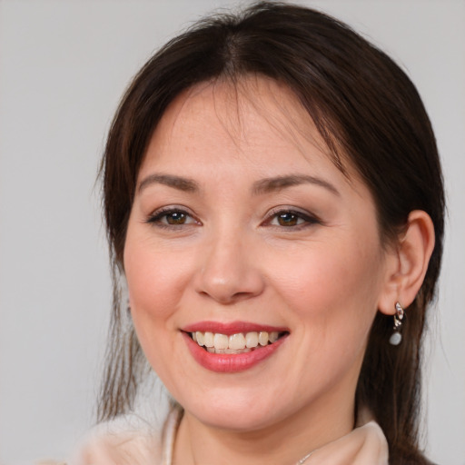 Joyful white young-adult female with medium  brown hair and brown eyes