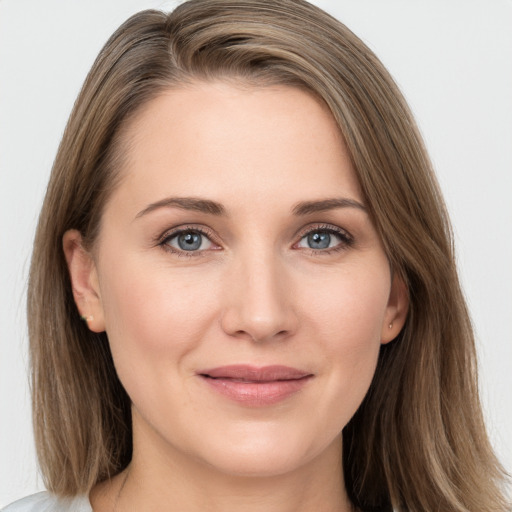 Joyful white young-adult female with long  brown hair and grey eyes