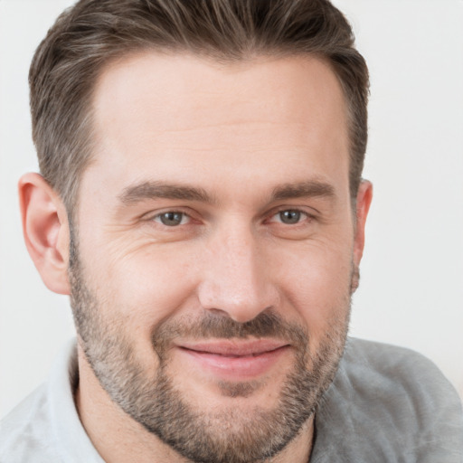 Joyful white adult male with short  brown hair and brown eyes