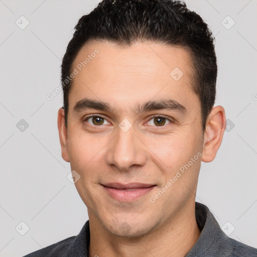 Joyful white young-adult male with short  black hair and brown eyes