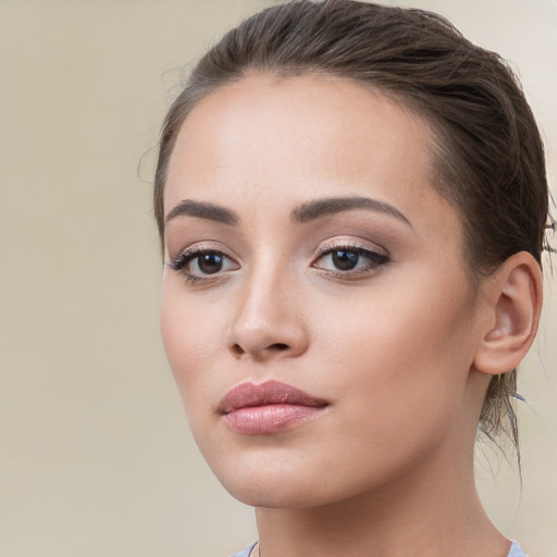 Neutral white young-adult female with long  brown hair and brown eyes