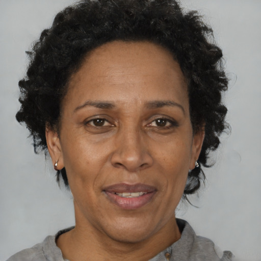 Joyful black adult female with short  brown hair and brown eyes