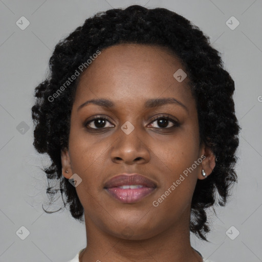 Joyful black young-adult female with long  black hair and brown eyes