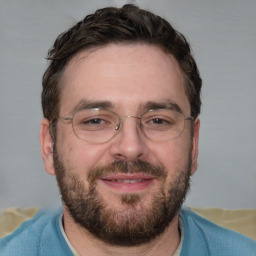 Joyful white adult male with short  brown hair and brown eyes