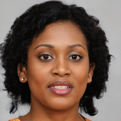 Joyful black young-adult female with medium  brown hair and brown eyes