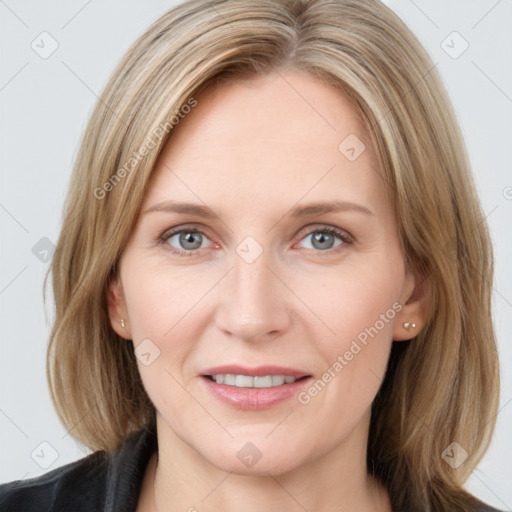 Joyful white adult female with medium  brown hair and blue eyes