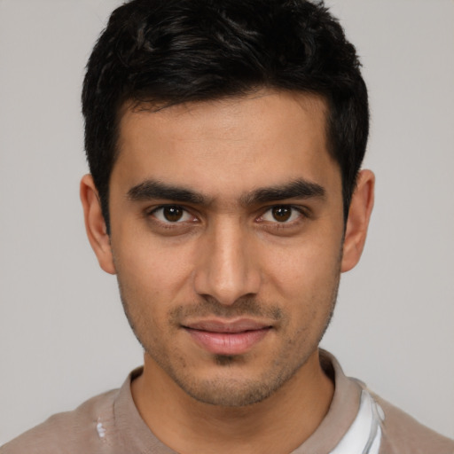 Joyful latino young-adult male with short  black hair and brown eyes