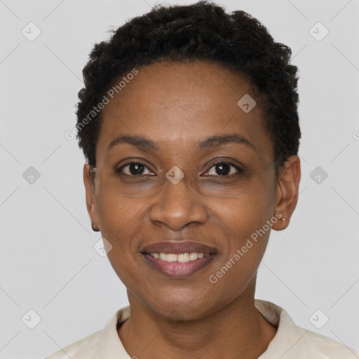 Joyful black young-adult female with short  black hair and brown eyes