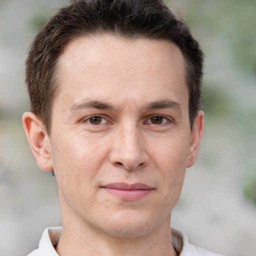 Joyful white adult male with short  brown hair and brown eyes