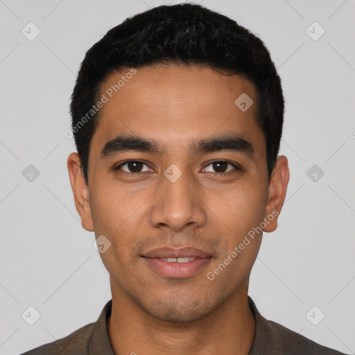 Joyful latino young-adult male with short  black hair and brown eyes