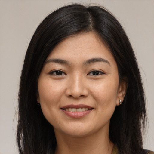 Joyful asian young-adult female with long  brown hair and brown eyes