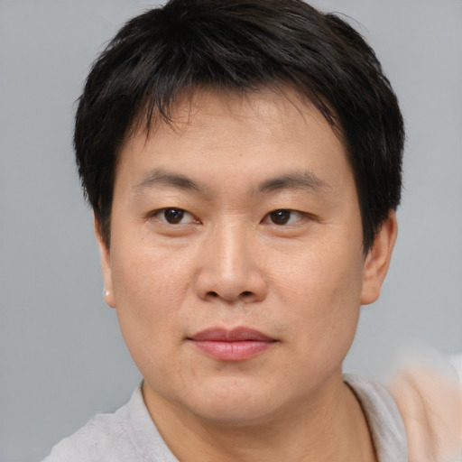 Neutral asian young-adult male with short  brown hair and brown eyes