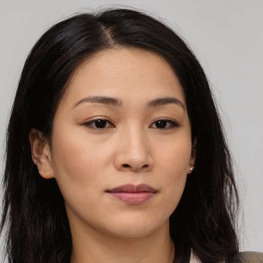 Joyful asian young-adult female with long  brown hair and brown eyes